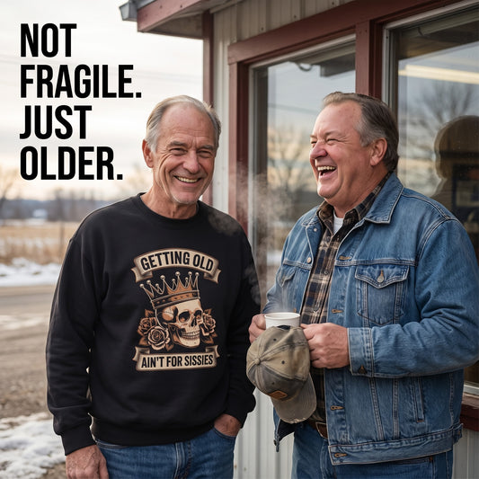 Senior man wearing black Getting Old sweatshirt near cabin with friend