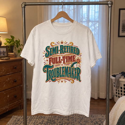 White vintage t-shirt hanging on rack with colorful Semi-Retired Full-Time Troublemaker print