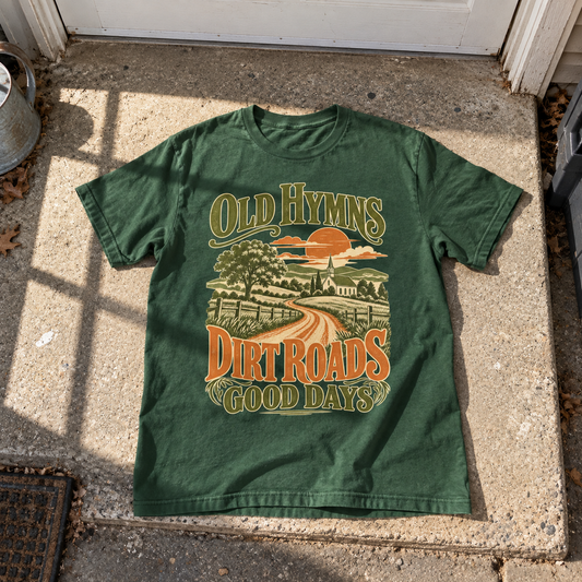 Green vintage t-shirt laid flat with printed Old Hymns Dirt Roads Good Days church scene