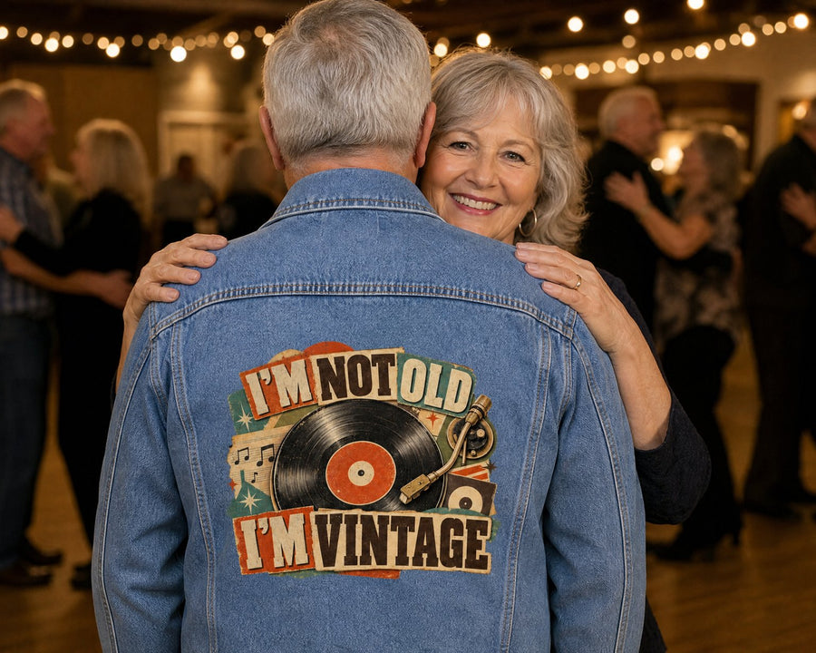 Couple dancing at a community hall, the denim jacket's design printed large on his back