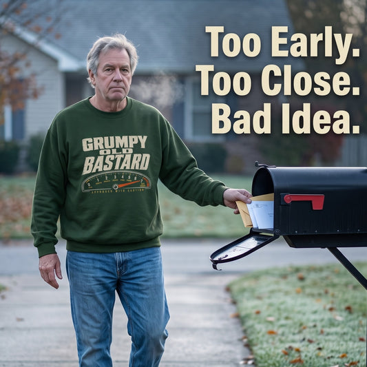 Senior man wearing green Grumpy Old Bastard sweatshirt at roadside mailbox