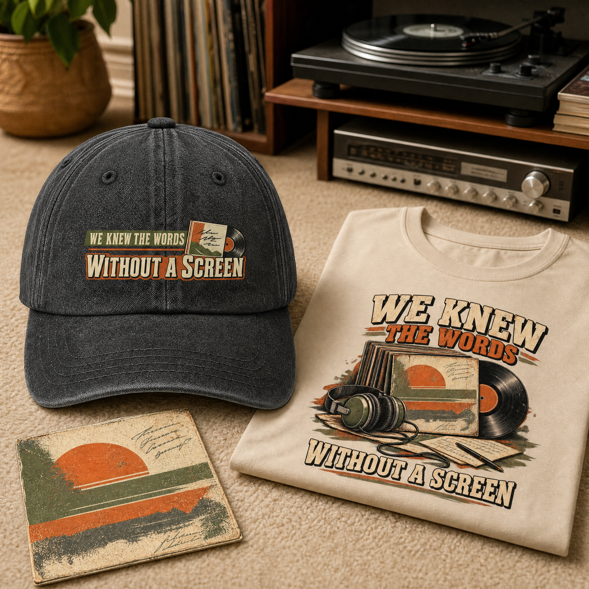 A dark washed baseball cap and a cream T-shirt both printed with the phrase “WE KNEW THE WORDS WITHOUT A SCREEN,” styled on a carpet with vinyl records, a turntable, and a small matching card in a retro room setting.