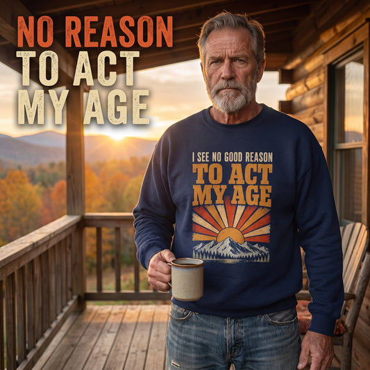 Senior man wearing navy Act My Age sweatshirt on cabin porch with mug