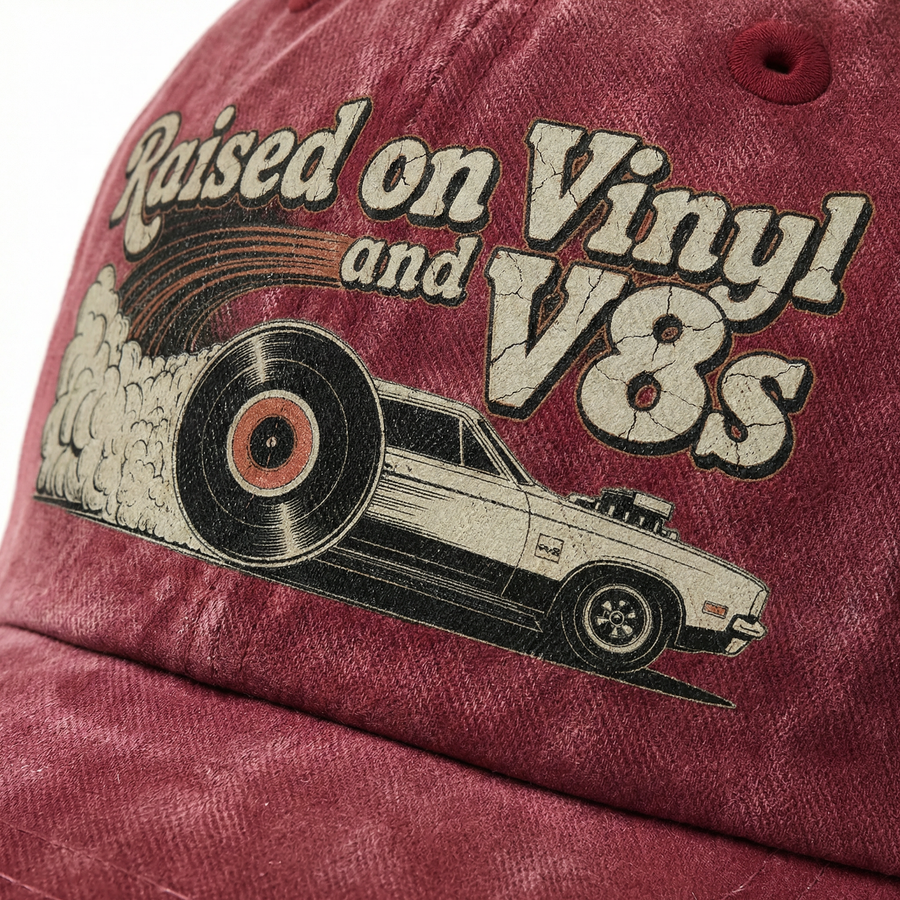 Close-up burgundy cap with Raised on Vinyl and V8s printed design