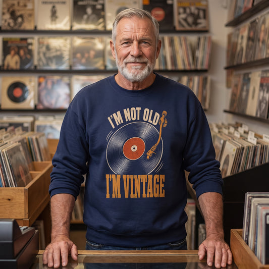 Man in navy sweatshirt browsing records in a crowded vinyl shop