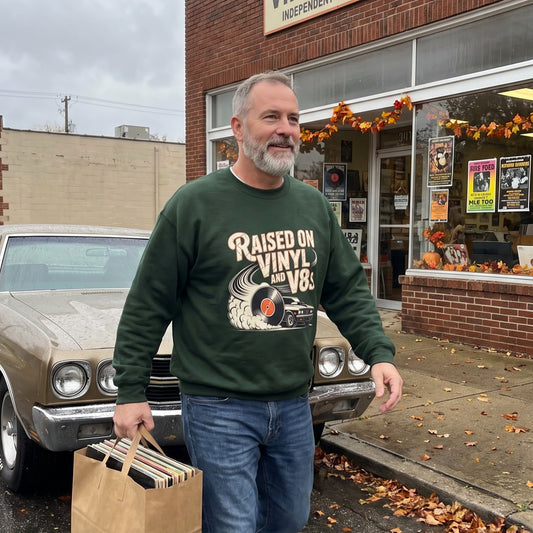 Senior man wearing green Raised on Vinyl and V8s printed sweatshirt outside