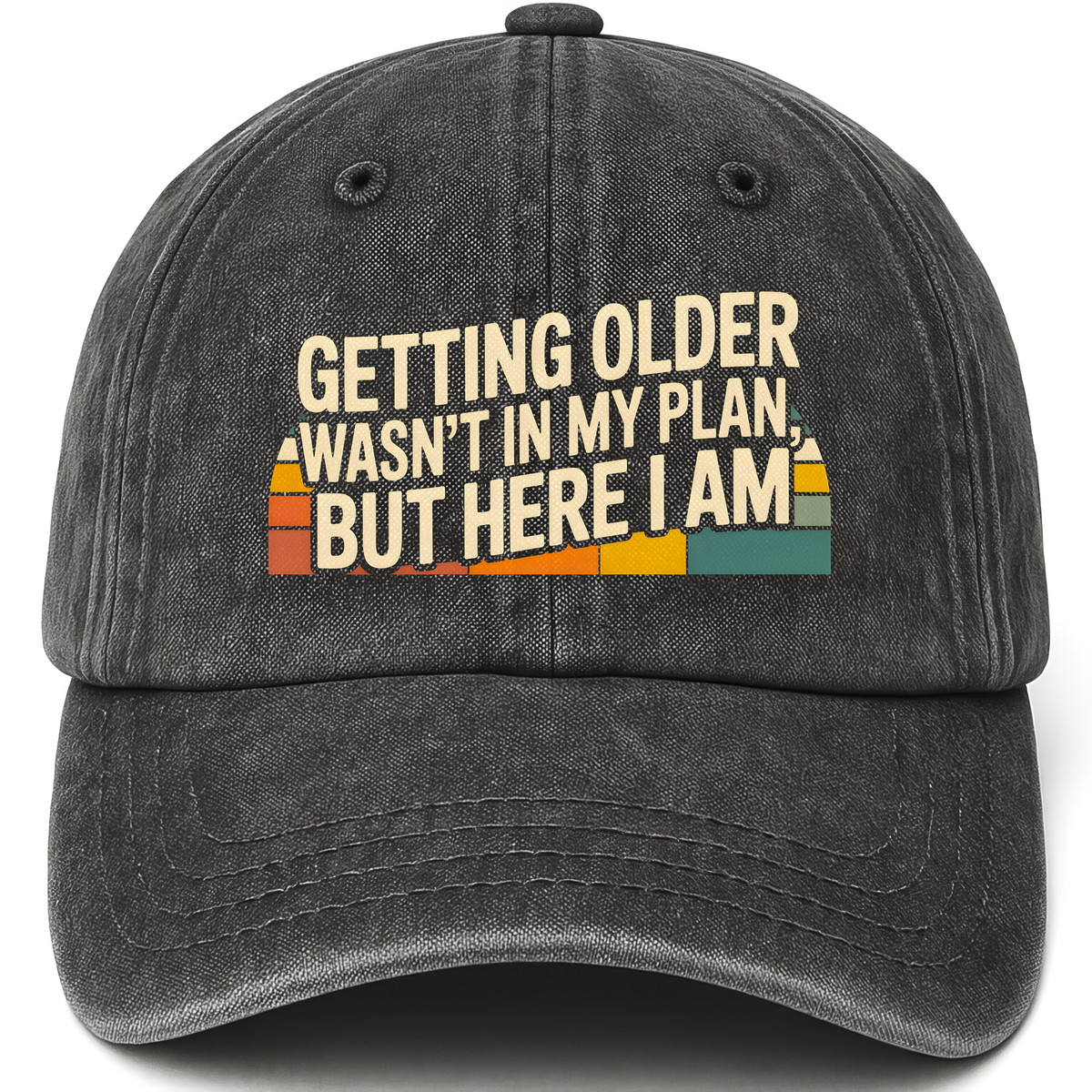 Black vintage washed cap with “Getting Older Wasn’t in My Plan, But Here I Am.” Sunset Fade Reality Cap printed front design