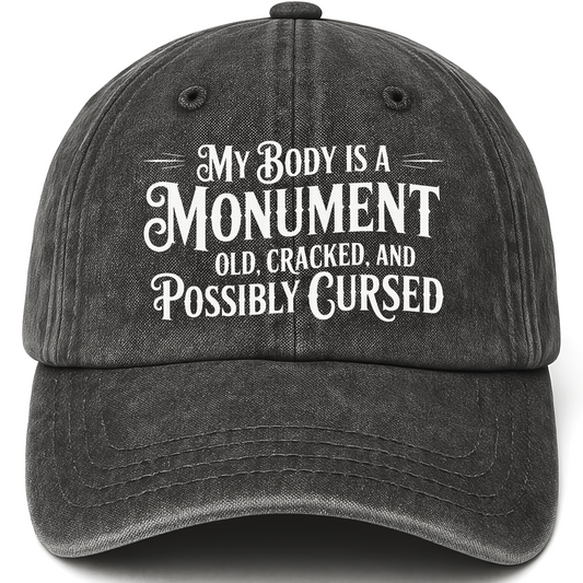 Black vintage washed cap with “My Body Is a Monument. Old, Cracked, and Possibly Cursed.” Gothic Humor Script Cap printed fro