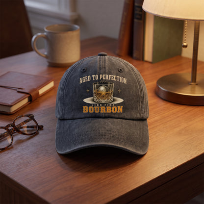 Black Aged To Perfection bourbon cap displayed on bedside table