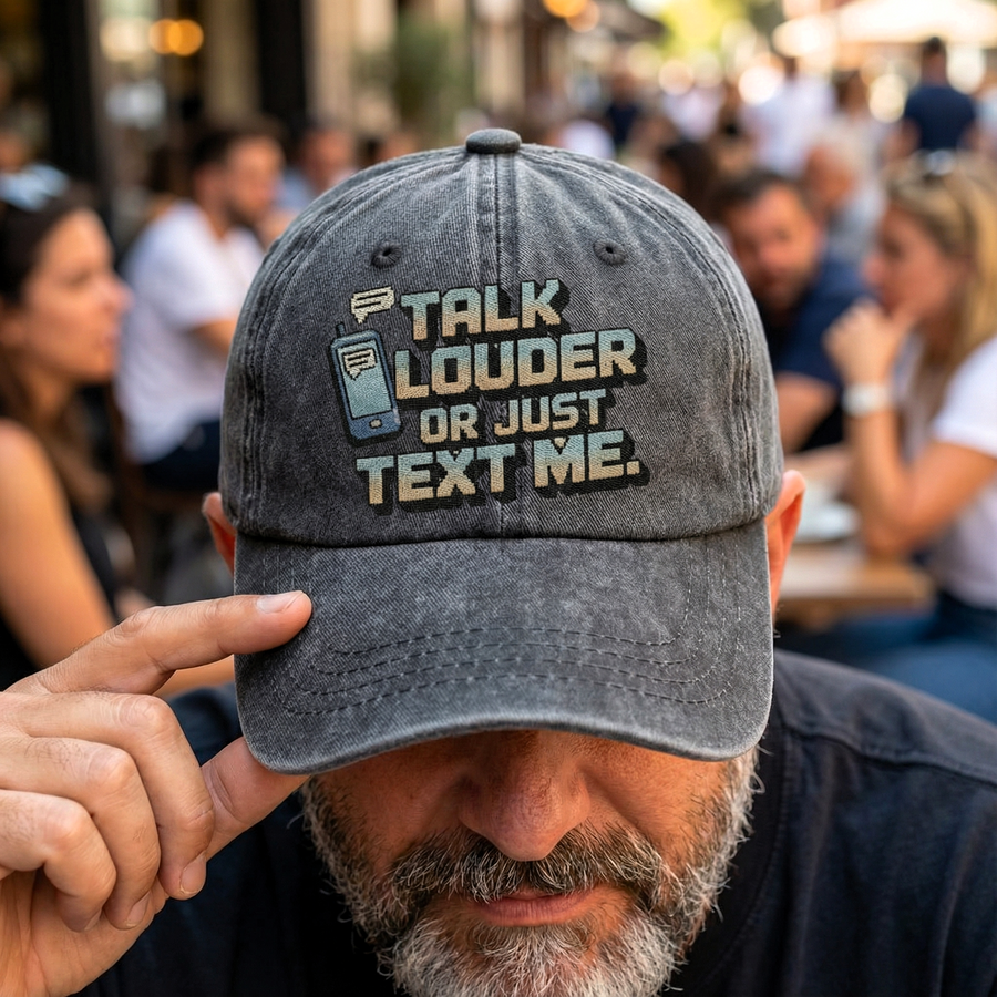 Man tilting gray Talk Louder cap with printed phone graphic design