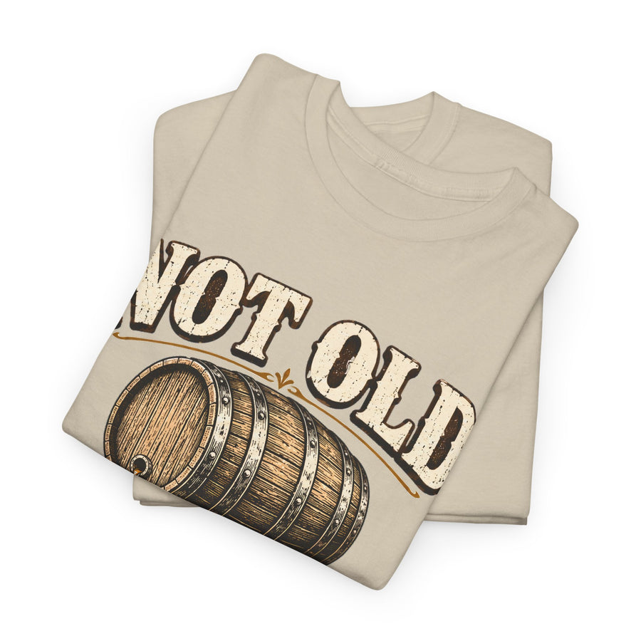 Folded cream T-shirt showing barrel graphic and Not Old print
