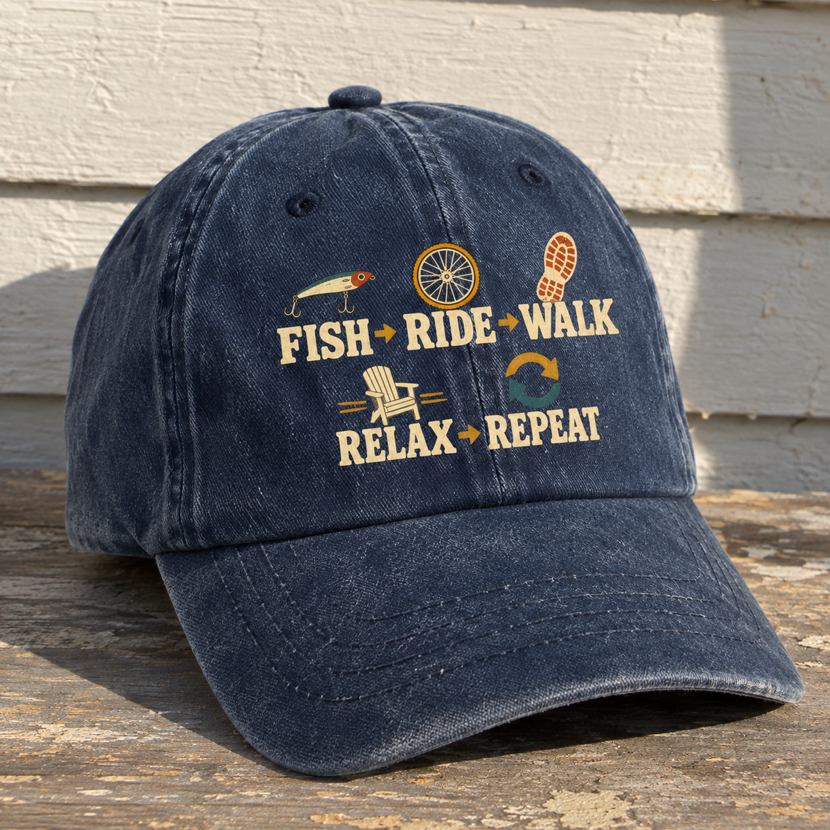 Navy vintage washed cap featuring printed Fish Ride Walk Relax Repeat slogan, shown at an angle.