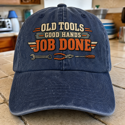 Blue vintage washed cap with printed Old Tools Good Hands Job Done slogan, angled front view