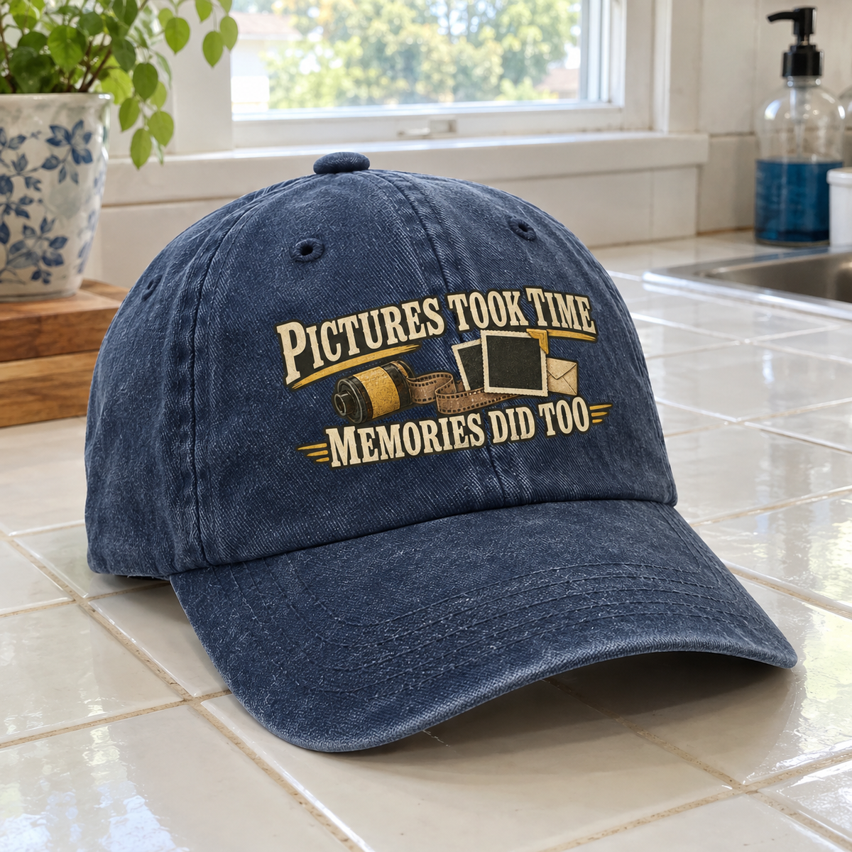Blue vintage washed cap printed with “Pictures Took Time. Memories Did Too” slogan, front angle