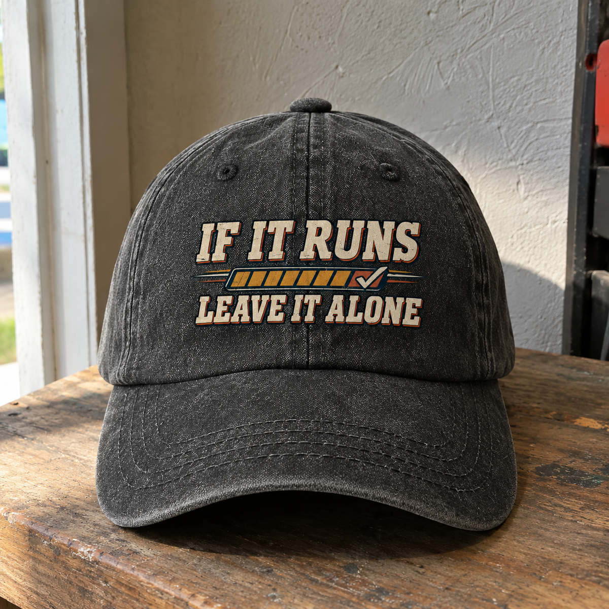 Black vintage washed cap with printed “If It Runs Leave It Alone” slogan, front angle