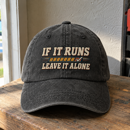 Black vintage washed cap with printed “If It Runs Leave It Alone” slogan, front angle