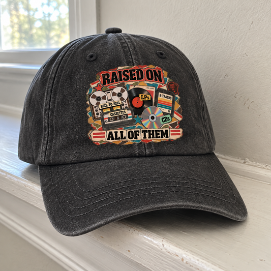 Black vintage washed cap, angled view, printed Raised On All Of Them music graphic