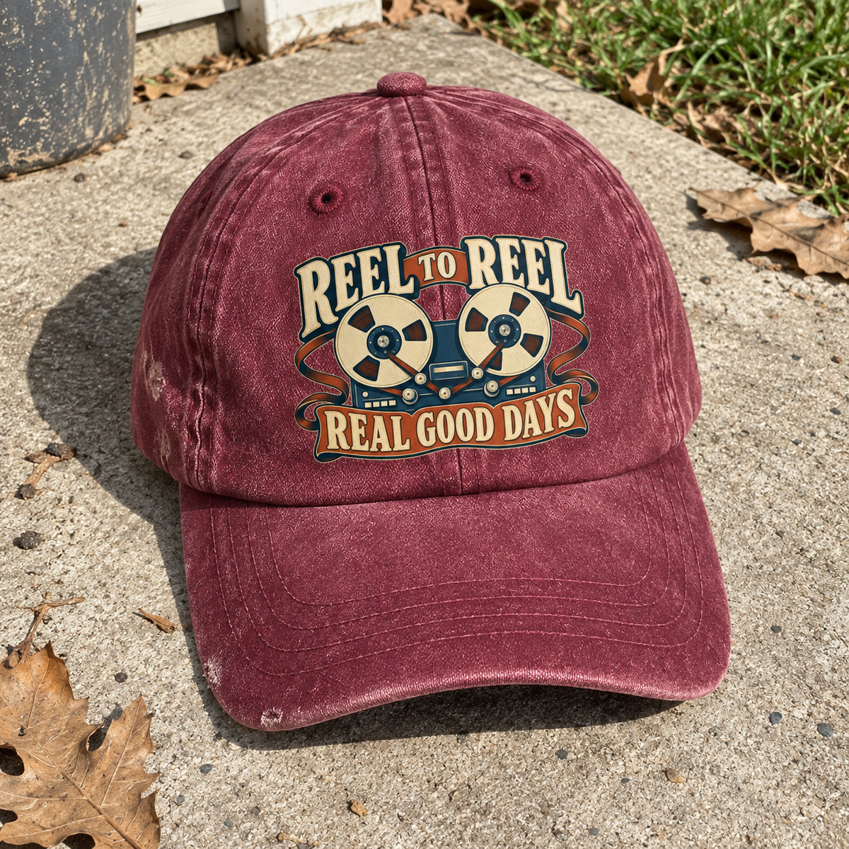 Angled view of burgundy vintage washed cap with printed Reel To Reel Real Good Days