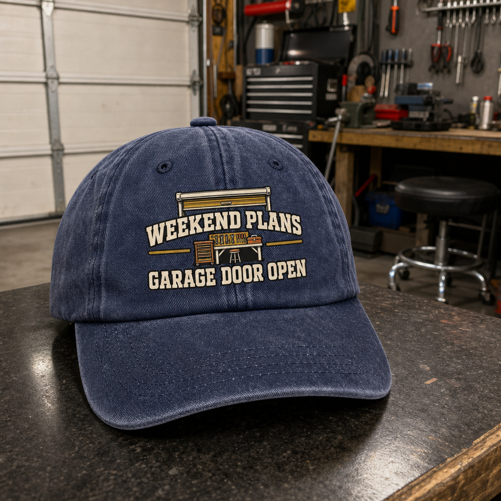 Vintage washed cap with Weekend Plans Garage Door Open printed design, angled view in a garage