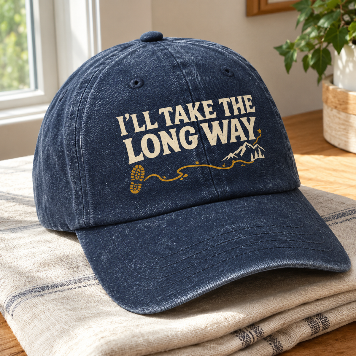 Navy vintage washed cap with printed I’ll Take The Long Way trail design, angled view
