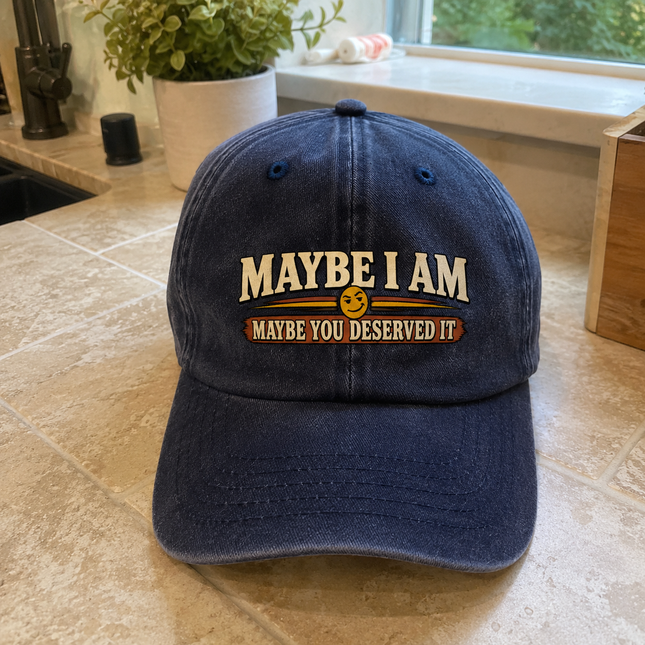 Dark blue vintage washed cap with printed “Maybe I Am. Maybe You Deserved It” slogan, front angle