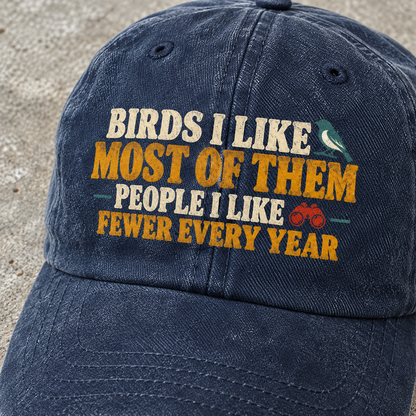 Navy vintage washed cap with printed bird slogan and binocular graphic, angled close-up view
