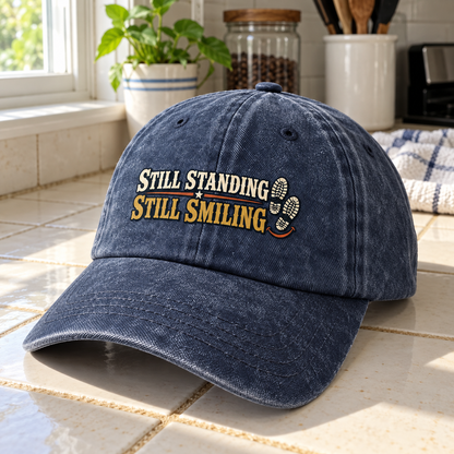 Navy vintage washed cap on kitchen counter, angled view, printed Still Standing Still Smiling.