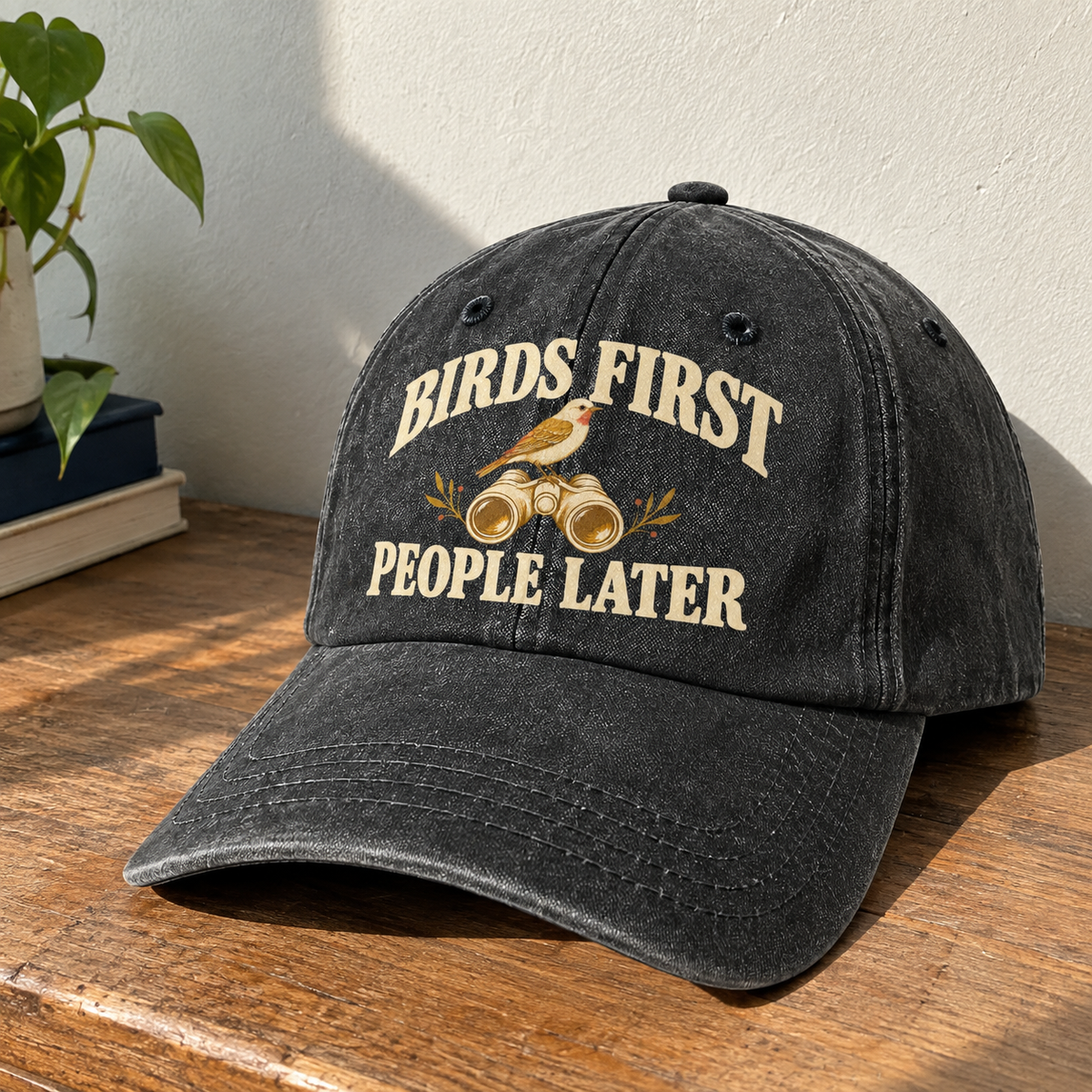 Black vintage washed cap with printed Birds First People Later slogan angled view
