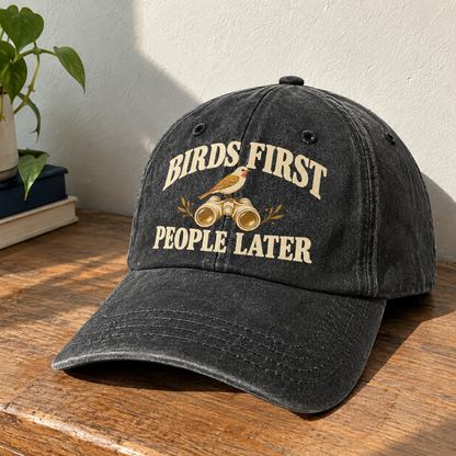 Black vintage washed cap with printed Birds First People Later slogan angled view