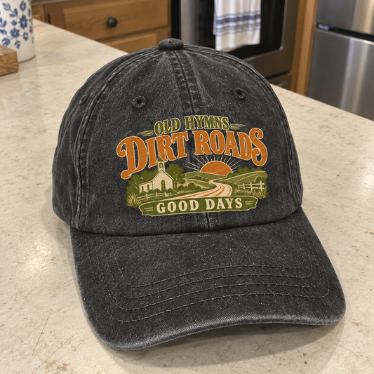 Close-up angle views of vintage washed cap with Old Hymns Dirt Roads Good Days printed design