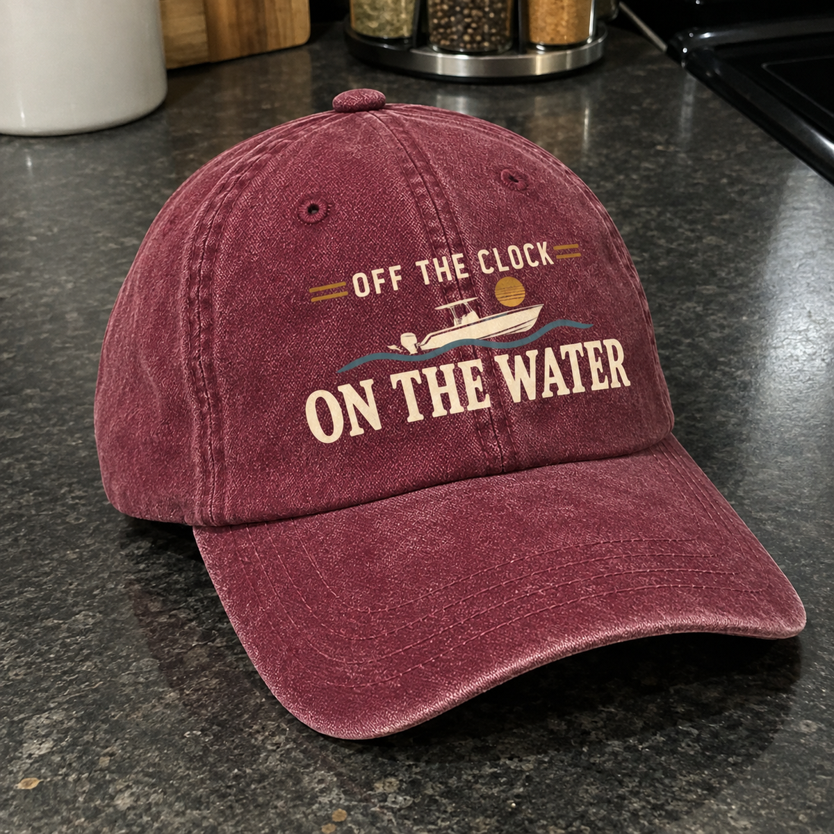 Maroon vintage washed cap with printed Off The Clock On The Water slogan angled view
