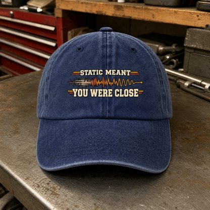 Navy vintage washed cap with printed Static Meant You Were Close slogan, front view