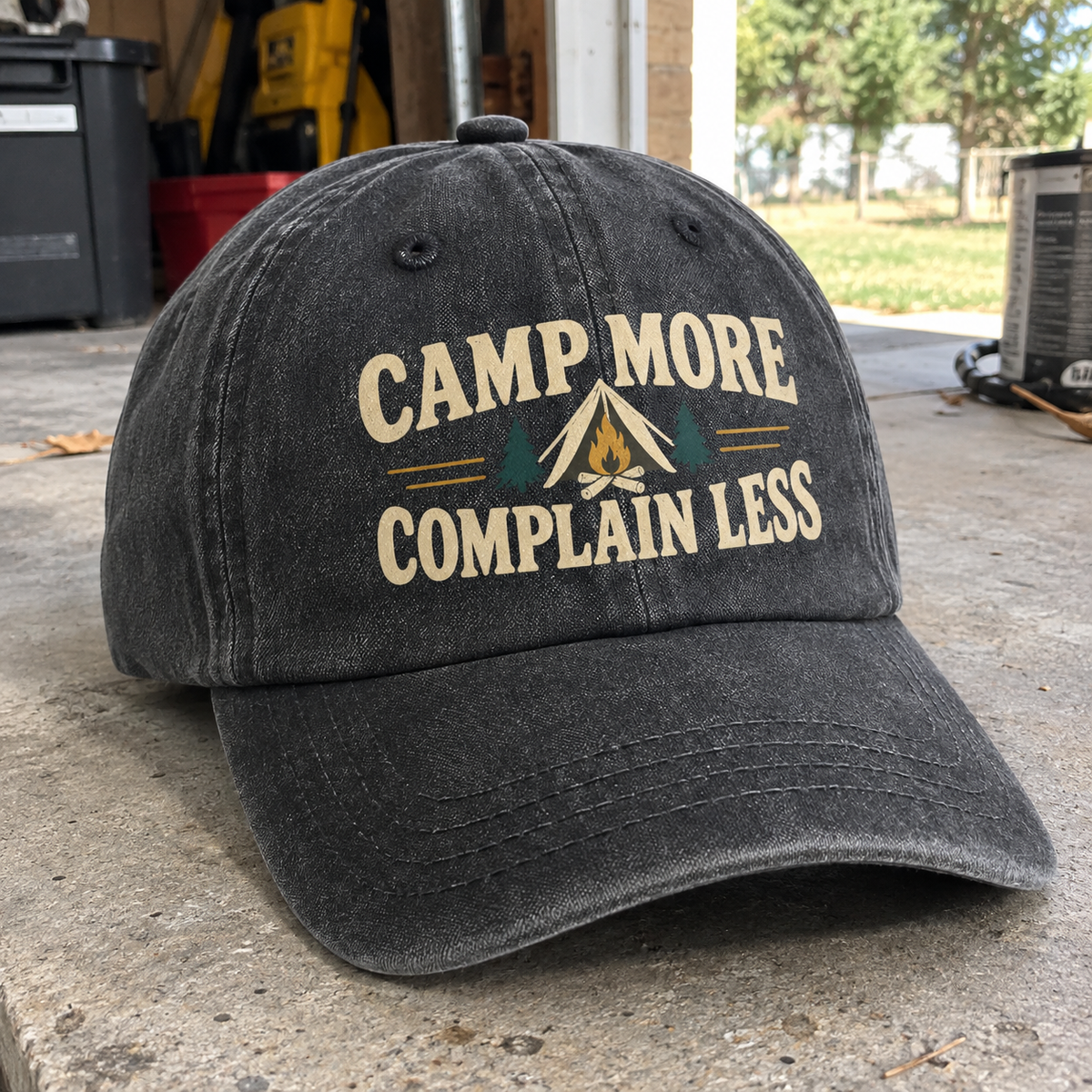 Black vintage washed cap with printed Camp More Complain Less camping design, angled view