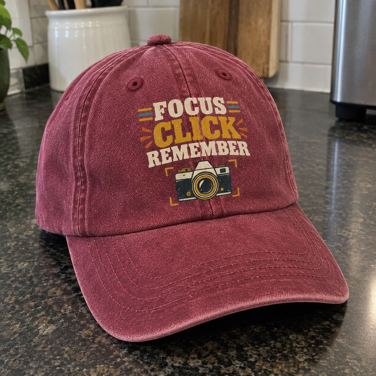 maroon vintage washed cap with Focus Click Remember print and camera graphic angled view