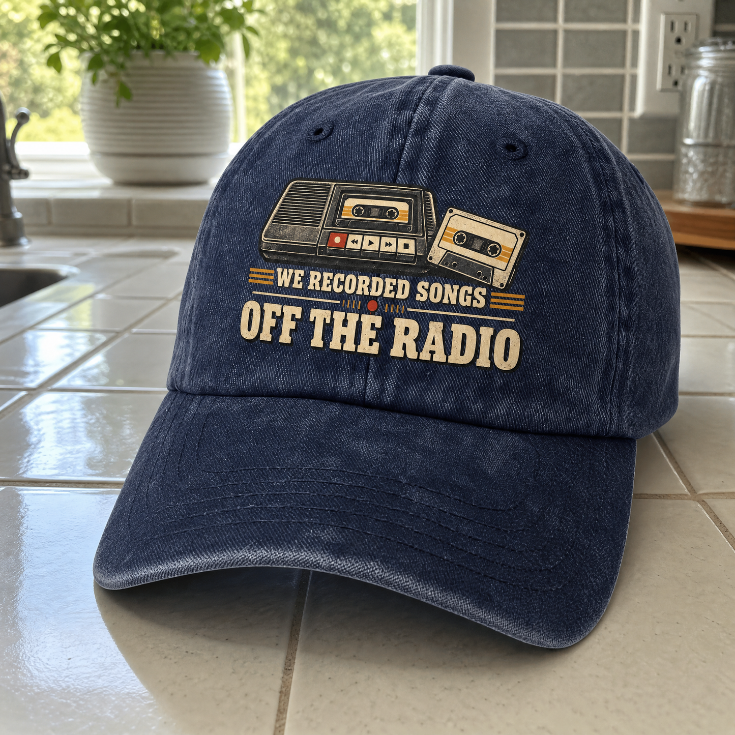 Navy vintage washed cap with printed “We Recorded Songs Off The Radio” design, front angle.
