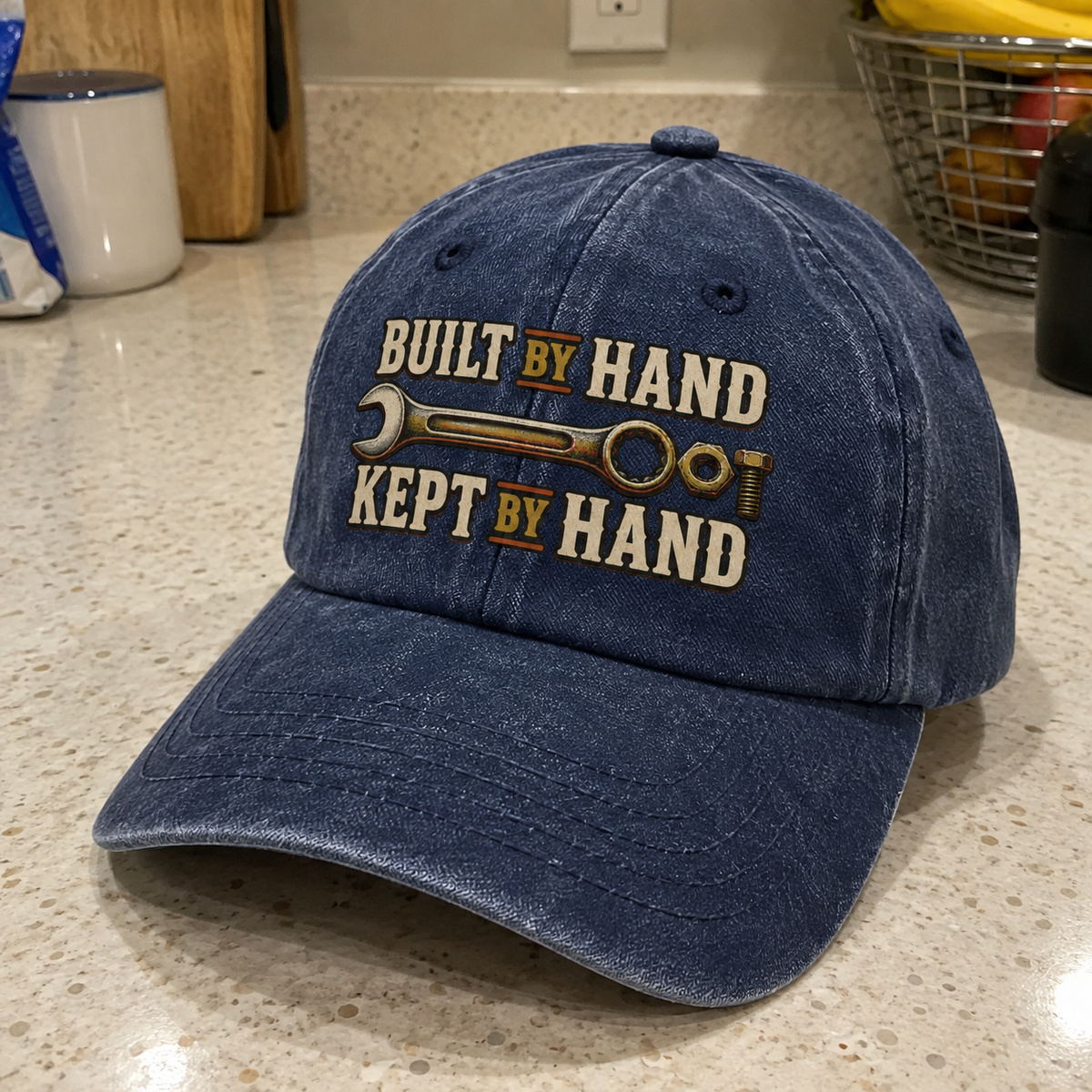 Navy blue vintage washed cap with printed Built By Hand. Kept By Hand slogan.