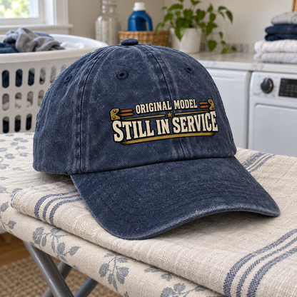 Navy vintage washed cap with printed Original Model Still In Service slogan, angled view.