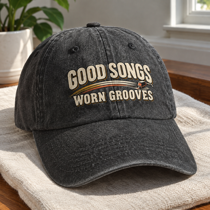 Black vintage washed cap with printed Good Songs Worn Grooves design, angled view.