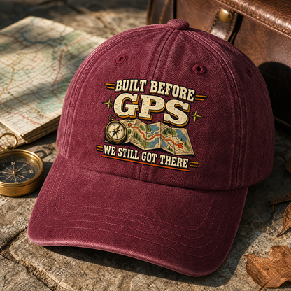 Burgundy vintage washed cap, printed “Built Before GPS We Still Got There” slogan, angled view.