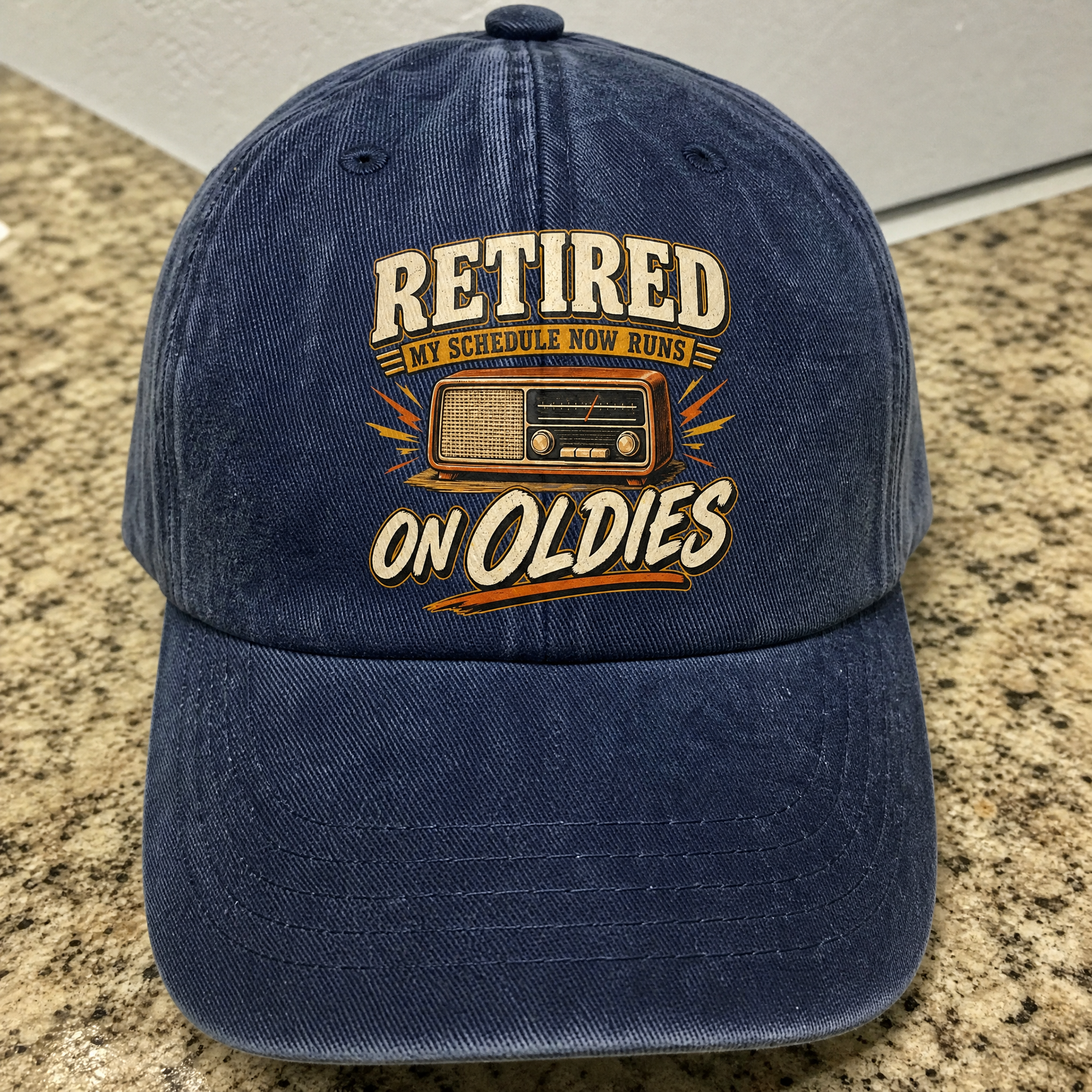 Vintage washed cap with printed “39 schedule runs on oldies” design, angled view