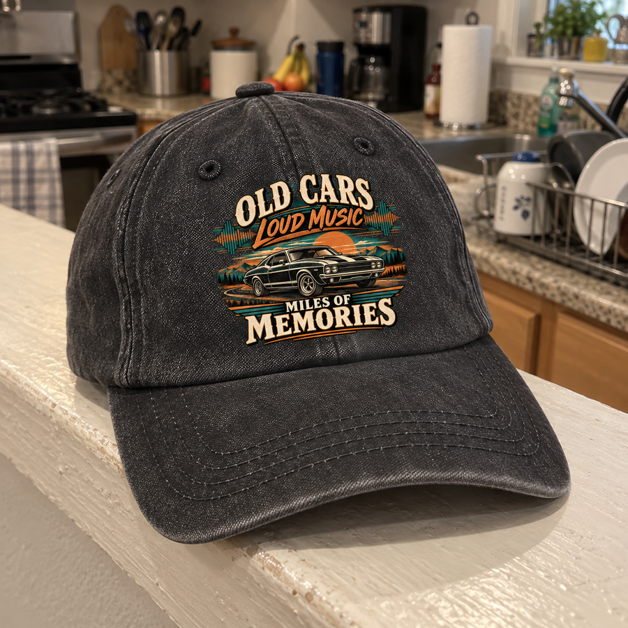 Angled view of charcoal vintage washed cap with printed Old Cars, Loud Music, Miles of Memories design