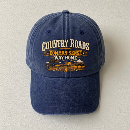 Close-up angle views of vintage washed cap with Country Roads. Common Sense Way Home printed design