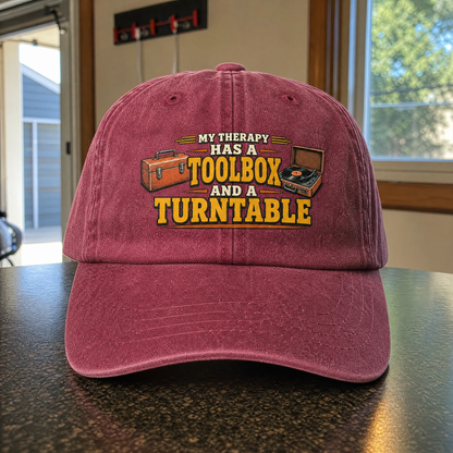 Vintage washed cap with printed 33 toolbox and turntable design, angled view