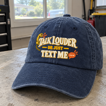 Dark blue vintage washed cap with printed Talk Louder Or Just Text Me slogan, angled.