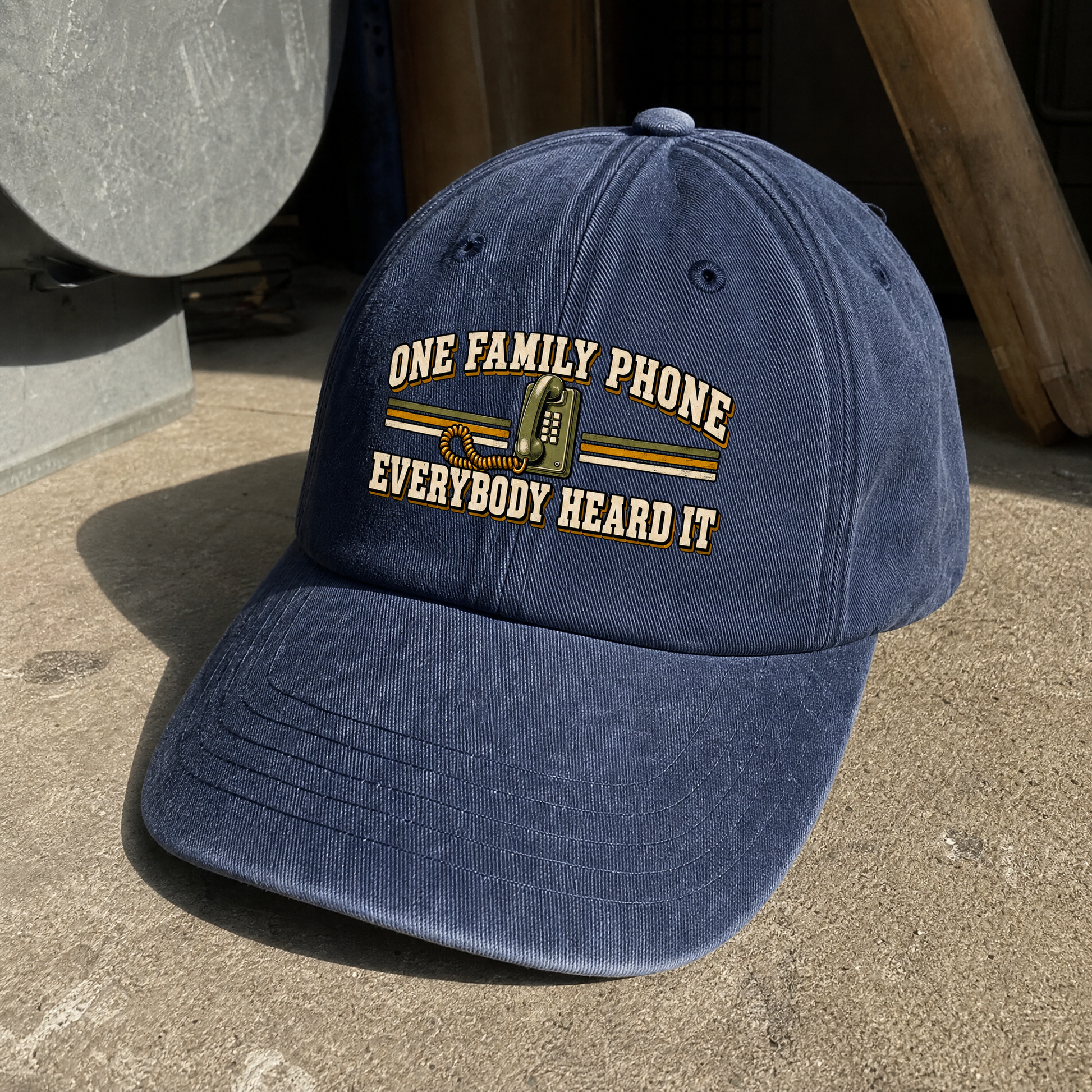 Navy vintage washed cap featuring printed One Family Phone. Everybody Heard It slogan, angled view.