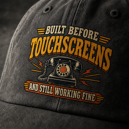Black vintage washed cap with printed “Built Before Touchscreens And Still Working Fine” slogan, angled view