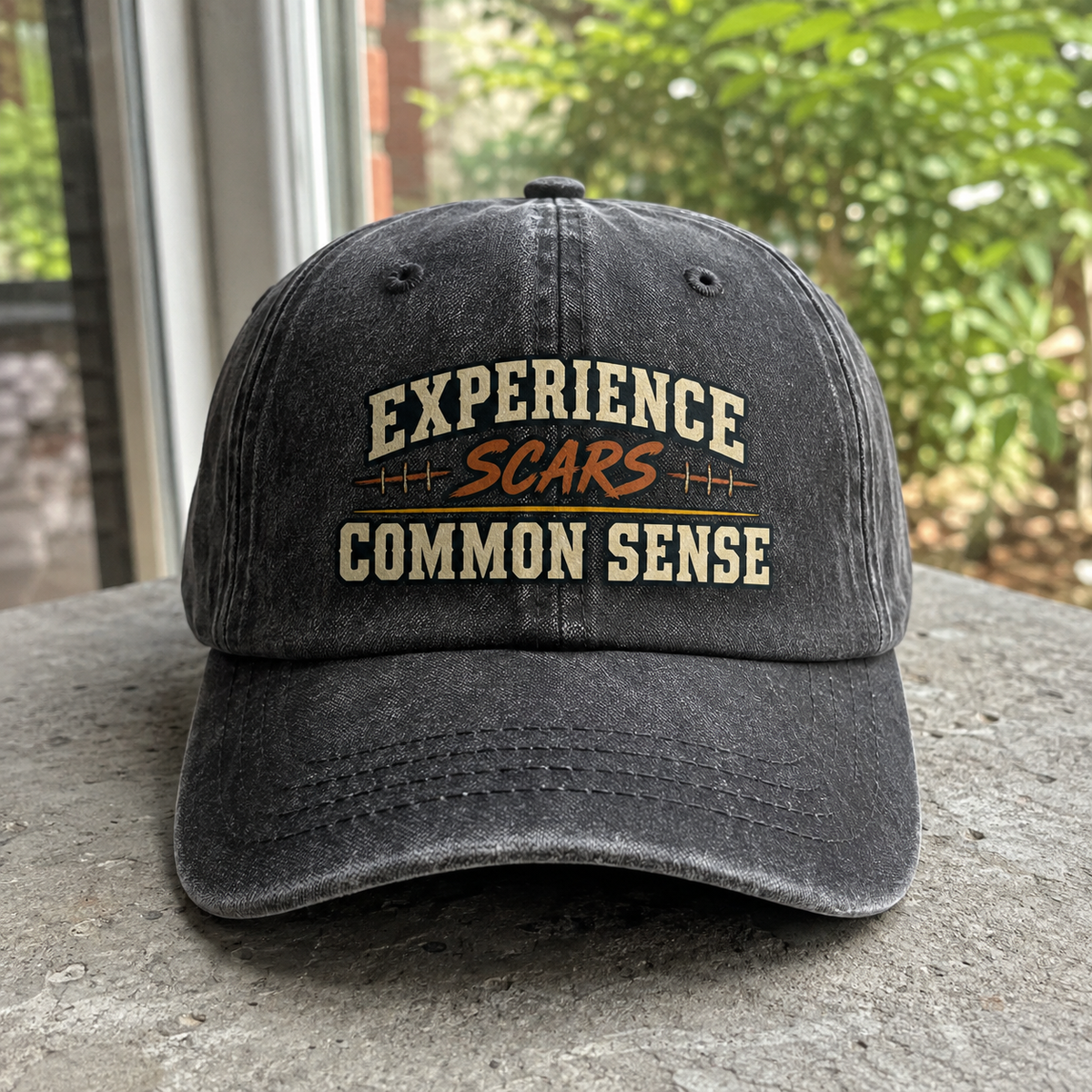 Black vintage washed cap featuring printed Experience Scars. Common Sense slogan, front angle.