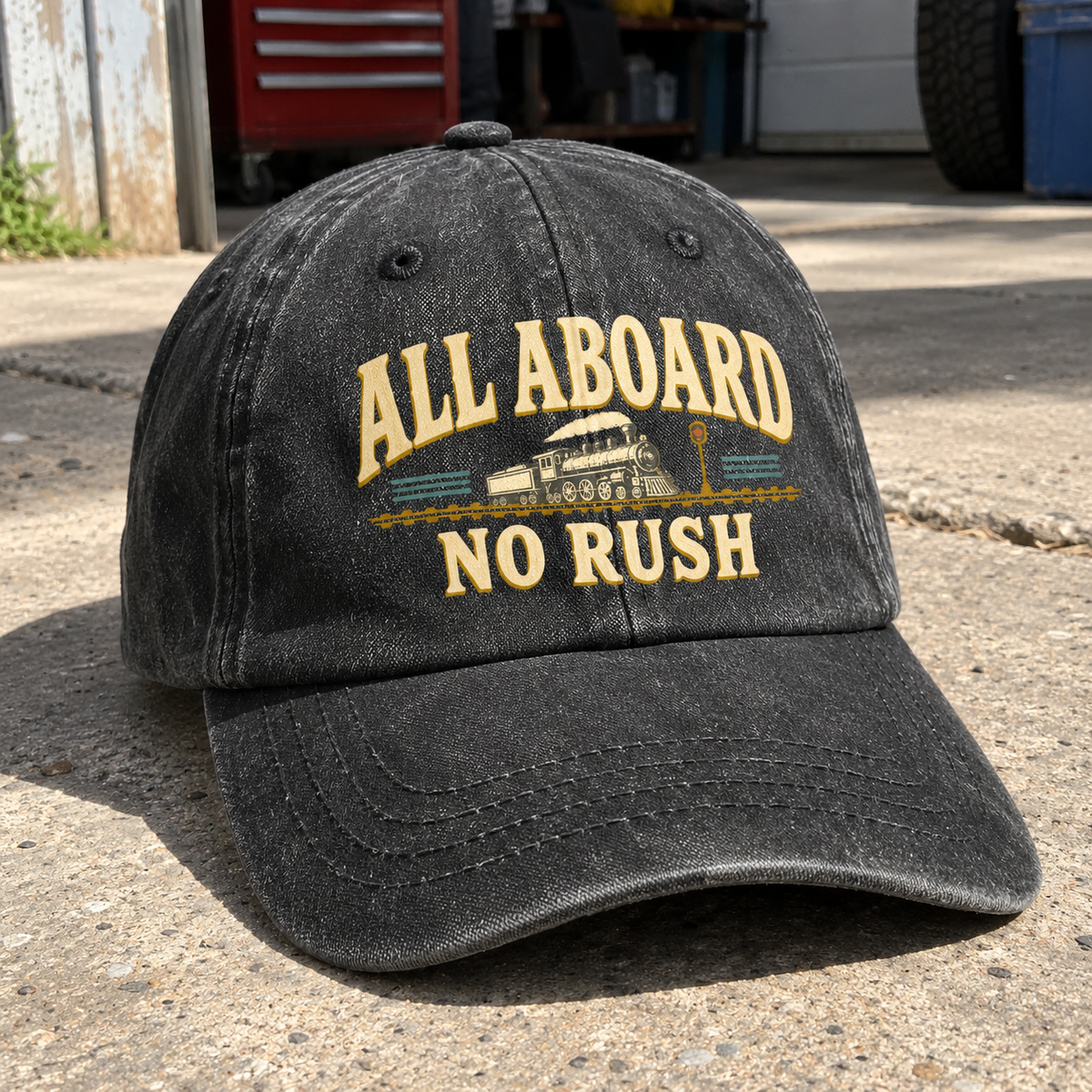 Close-up angle views of vintage washed cap with All Aboard. No Rush printed design
