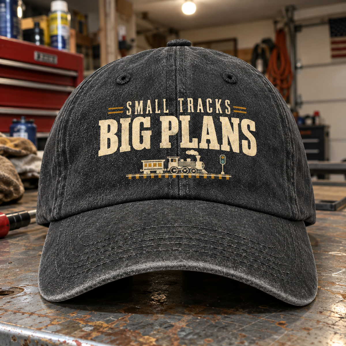 Black vintage washed cap with printed Small Tracks Big Plans slogan, front angle
