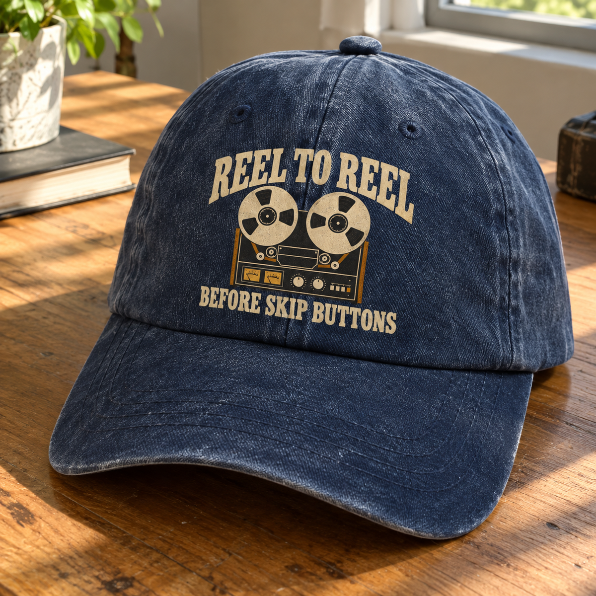 Navy vintage washed cap with printed reel-to-reel design and Reel To Reel slogan, angled view